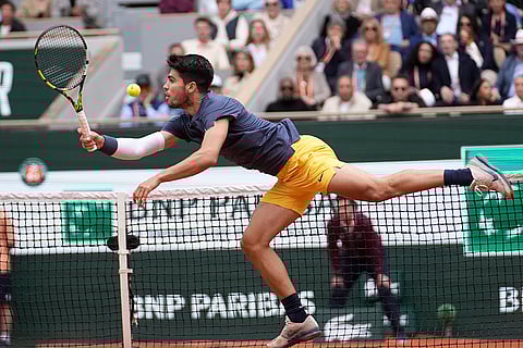 Carlos Alcaraz plays a shot against Felix Auger-Aliassime